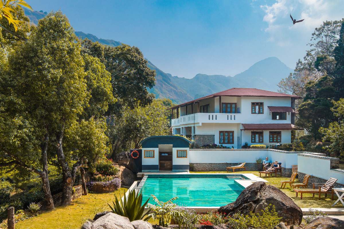 hotel and pool among the tea hills in kerala