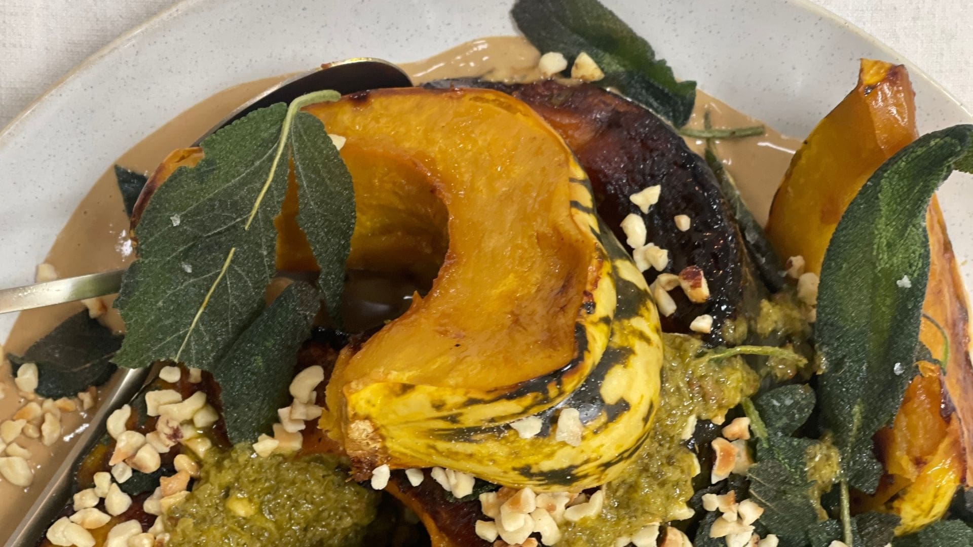 Roasted winter squash with miso tahini, crispy sage and hazelnuts”