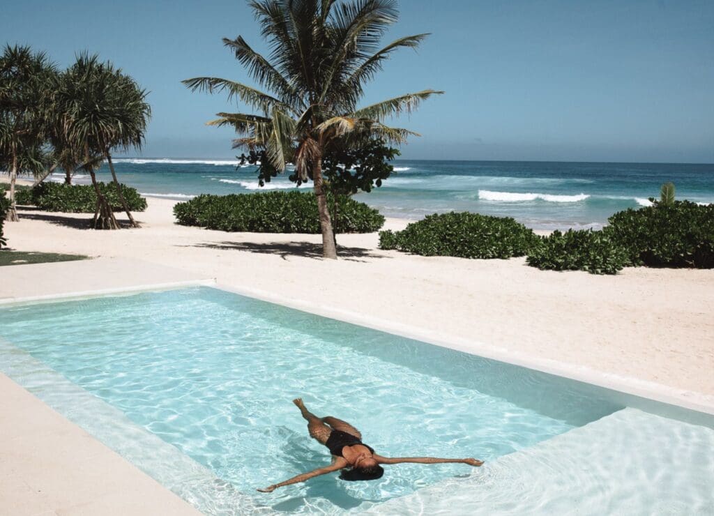 woman lying in pool on sumba island